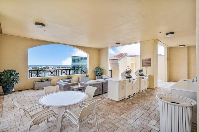 view of patio / terrace featuring grilling area, sink, and an outdoor hangout area