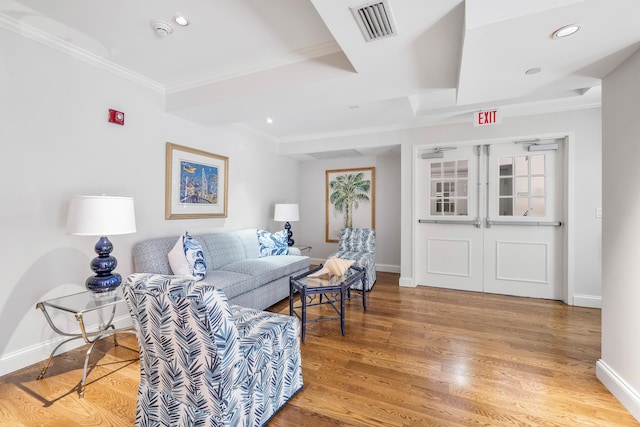 living room featuring hardwood / wood-style flooring and ornamental molding