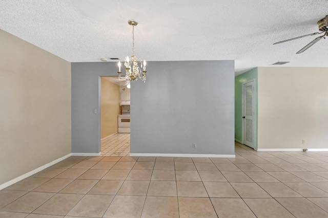 unfurnished room featuring ceiling fan with notable chandelier, light tile patterned flooring, and a textured ceiling