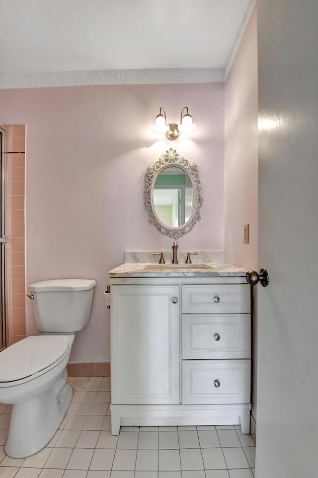 bathroom with tile patterned flooring, vanity, and toilet