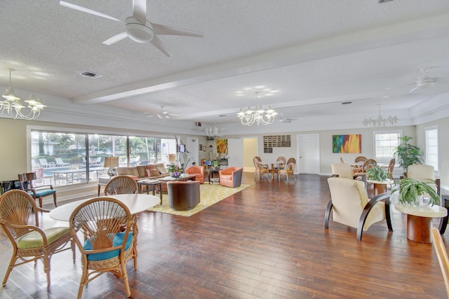 living room with a textured ceiling, ceiling fan with notable chandelier, beamed ceiling, and dark hardwood / wood-style floors