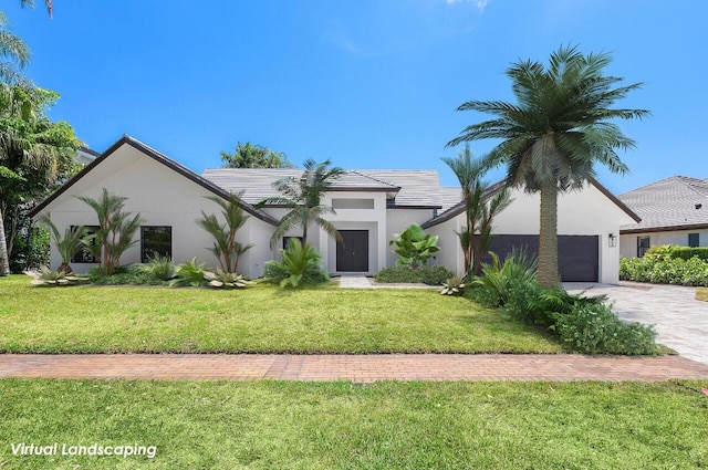 view of front of property with a front yard and a garage