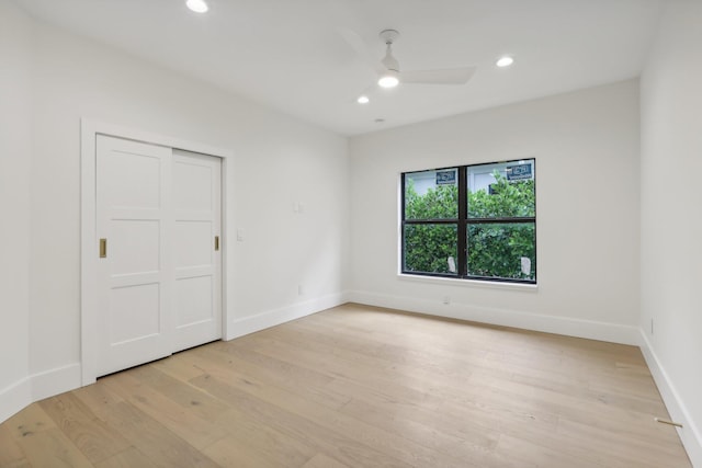 unfurnished bedroom with light hardwood / wood-style floors, a closet, and ceiling fan