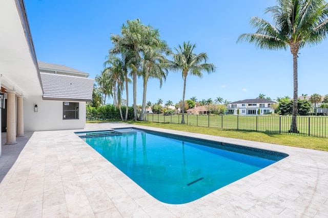 view of swimming pool featuring a patio and a lawn