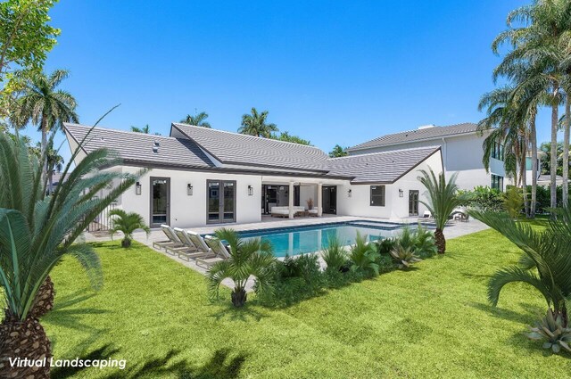 back of property featuring a yard and a patio area