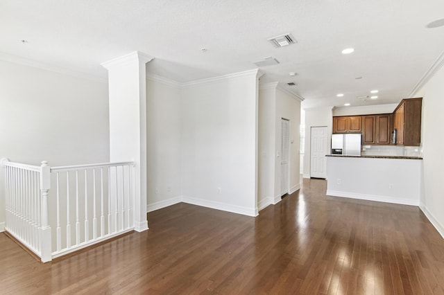 unfurnished living room featuring dark hardwood / wood-style floors and ornamental molding