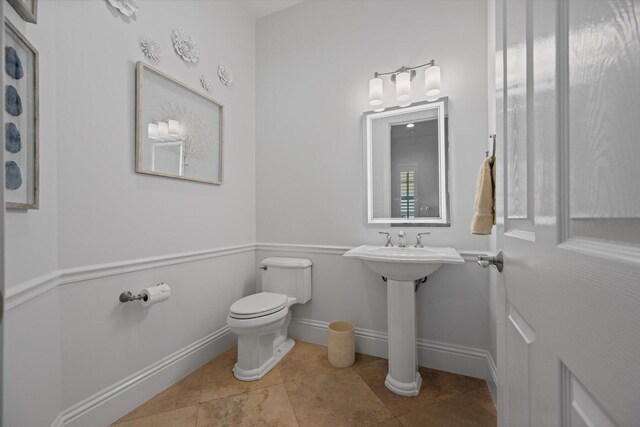 bathroom with tile flooring and toilet