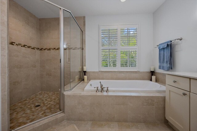 bathroom featuring tile flooring, vanity, and plus walk in shower