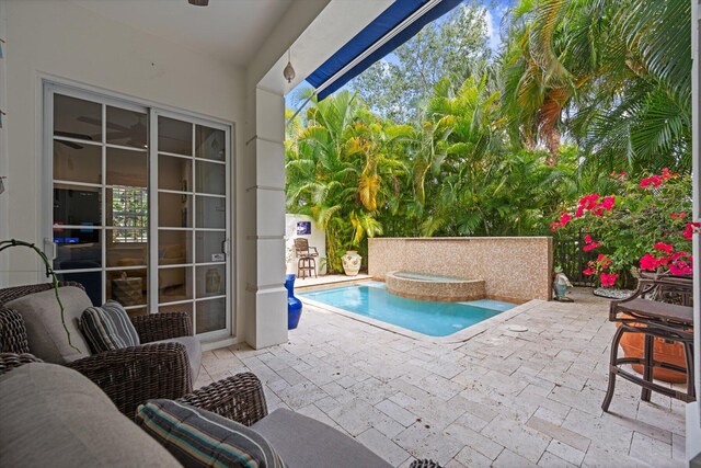 view of pool with a patio area and an in ground hot tub