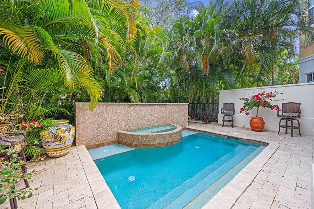 view of pool featuring an in ground hot tub and a patio