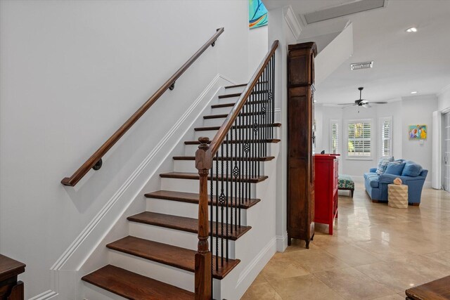 stairs featuring ceiling fan, light tile flooring, and crown molding