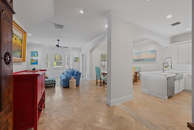 interior space featuring tile flooring, sink, ceiling fan, and crown molding