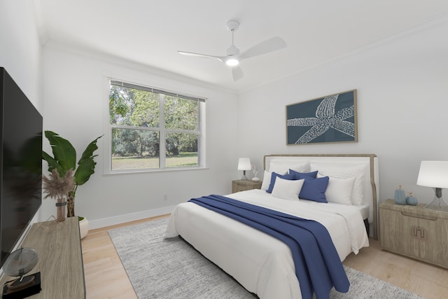 bedroom featuring light wood-type flooring, ceiling fan, and ornamental molding