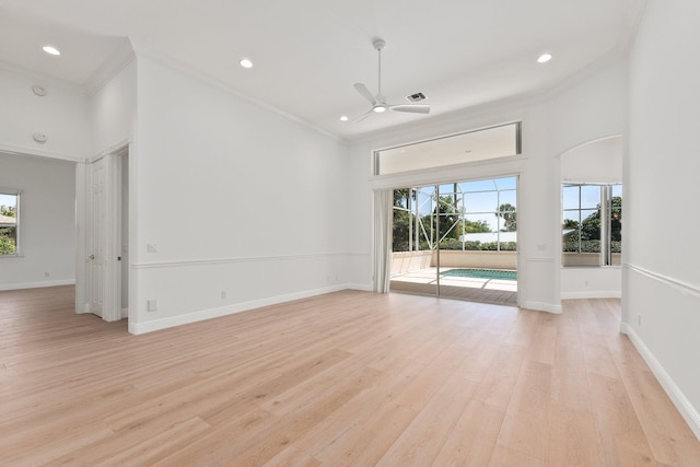 unfurnished living room featuring ornamental molding, ceiling fan, and light hardwood / wood-style floors