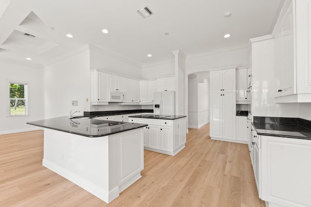 kitchen featuring ornamental molding, light wood-type flooring, white appliances, and white cabinetry