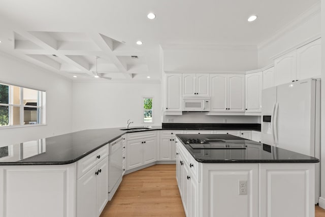 kitchen with coffered ceiling, white appliances, light hardwood / wood-style flooring, a center island, and ceiling fan