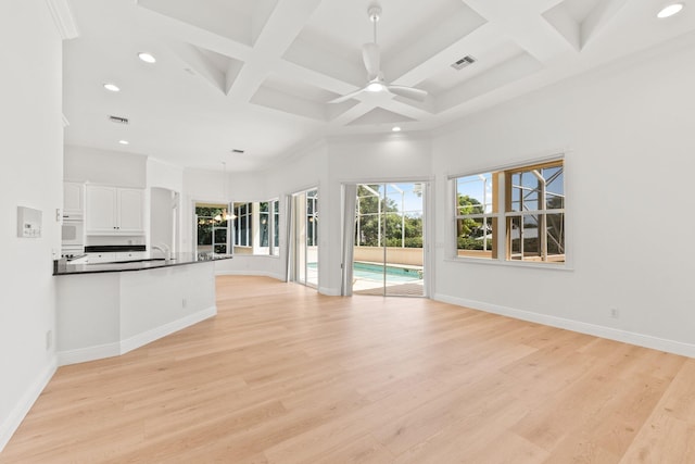 kitchen with white cabinetry, ceiling fan, and light hardwood / wood-style floors