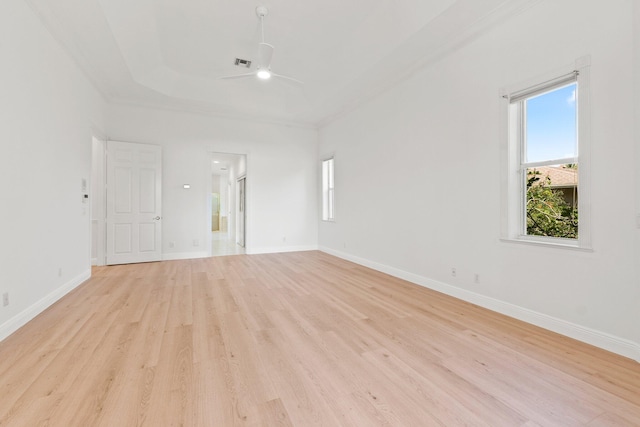 empty room featuring light hardwood / wood-style flooring, ceiling fan, and ornamental molding