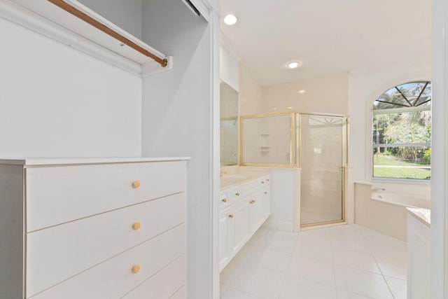 bathroom featuring vanity, plus walk in shower, and tile patterned flooring