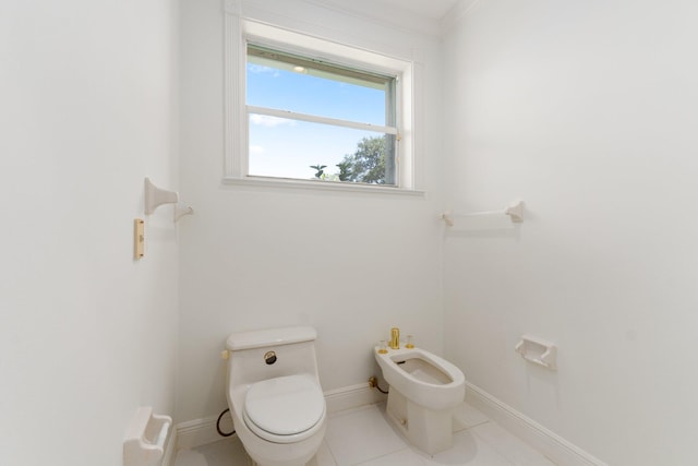 bathroom featuring ornamental molding, a bidet, toilet, and tile patterned flooring