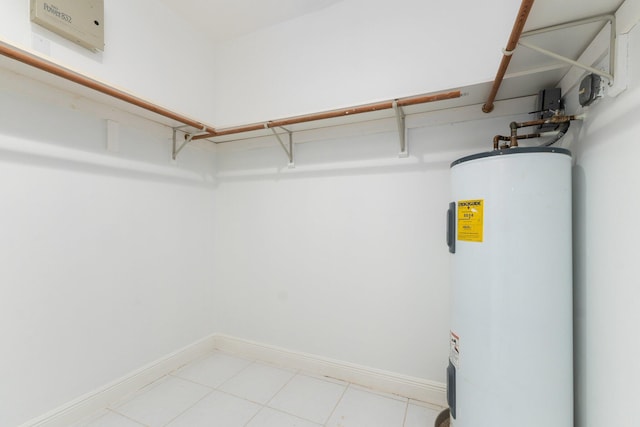 interior space featuring light tile patterned flooring and electric water heater