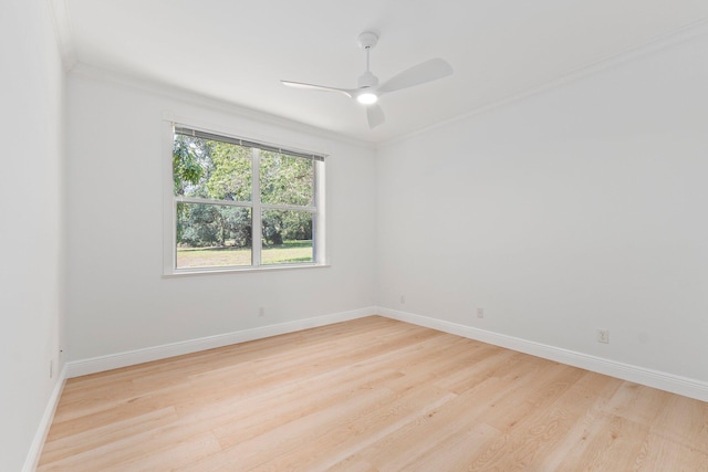 empty room with light wood-type flooring, crown molding, and ceiling fan