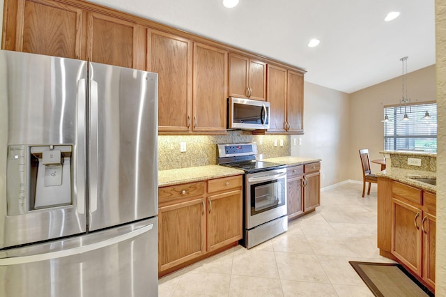 kitchen featuring stainless steel appliances, vaulted ceiling, light stone counters, and tasteful backsplash