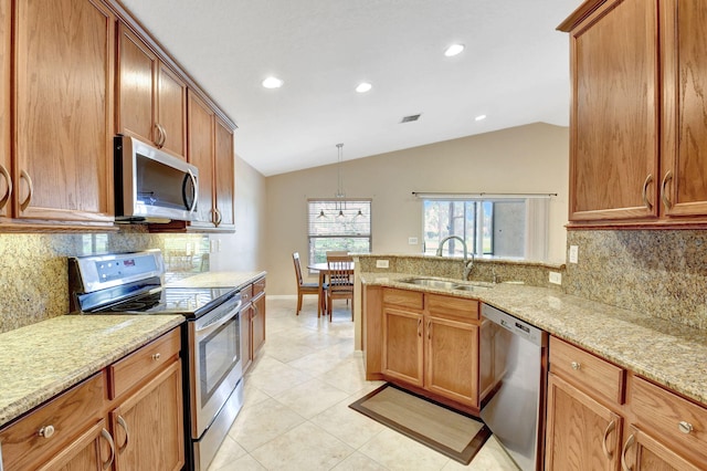 kitchen featuring tasteful backsplash, light tile flooring, vaulted ceiling, and stainless steel appliances