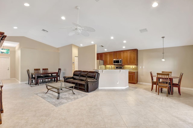 living room featuring vaulted ceiling, sink, ceiling fan, and light tile flooring