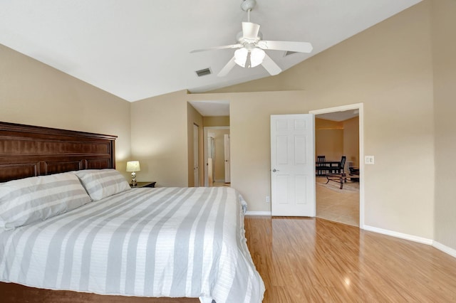 bedroom with lofted ceiling, ceiling fan, and light hardwood / wood-style flooring