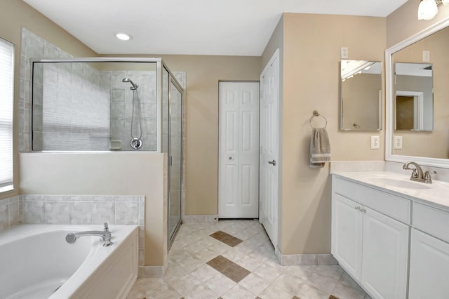 bathroom with tile floors, plus walk in shower, and vanity