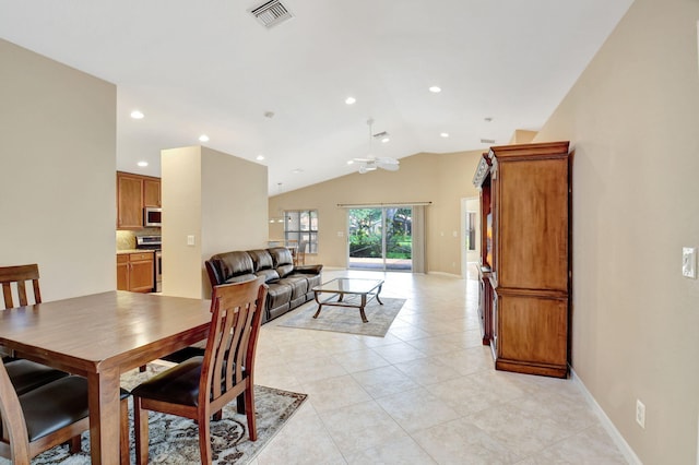 tiled dining space featuring lofted ceiling