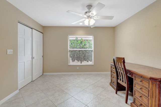 home office with ceiling fan and light tile flooring