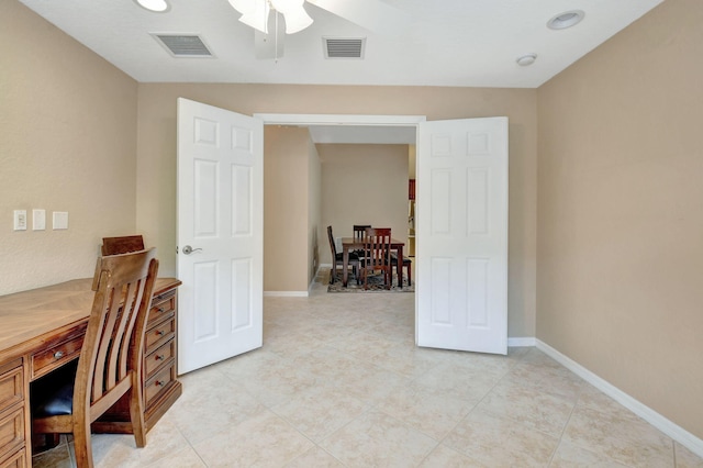 office space featuring ceiling fan and light tile floors