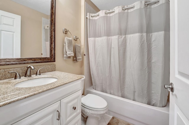 full bathroom with tile flooring, a textured ceiling, shower / tub combo with curtain, oversized vanity, and toilet