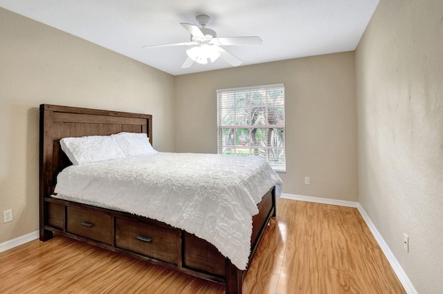 bedroom with ceiling fan and light wood-type flooring