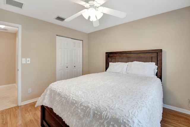 tiled bedroom featuring ceiling fan and a closet