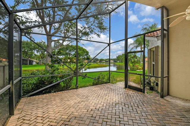 unfurnished sunroom with a water view