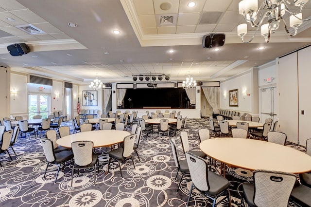 dining room with a notable chandelier, a raised ceiling, and crown molding