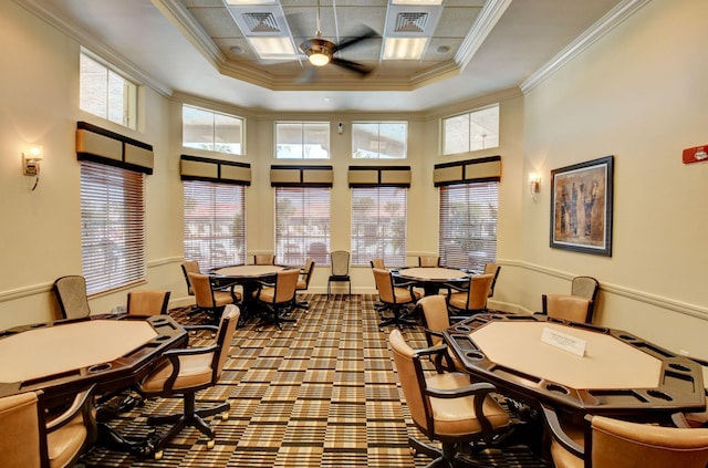 office area with ceiling fan, a high ceiling, a tray ceiling, and crown molding