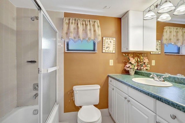 full bathroom with toilet, vanity, and enclosed tub / shower combo