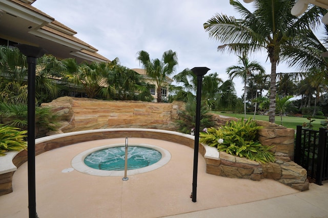 view of swimming pool featuring an in ground hot tub