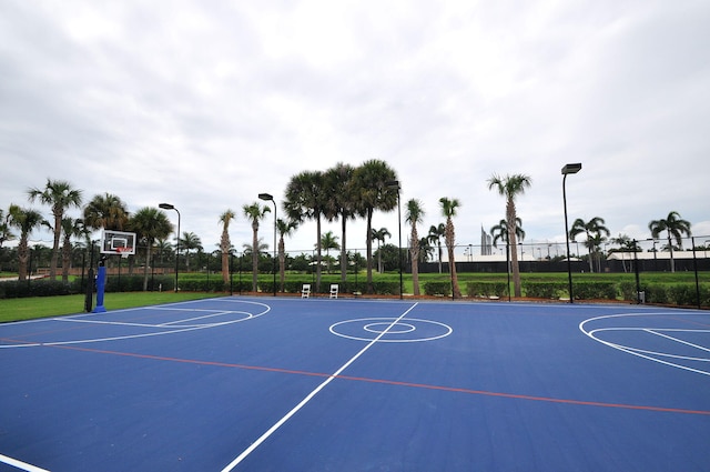 view of basketball court with community basketball court and fence