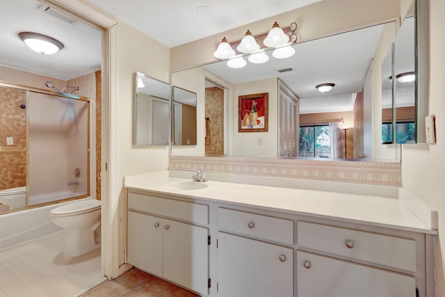 full bath featuring tile patterned flooring, toilet, shower / bath combination with glass door, visible vents, and vanity