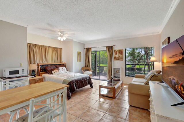 bedroom with light tile patterned floors, a ceiling fan, ornamental molding, access to exterior, and a textured ceiling