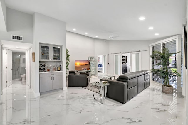 tiled living room featuring high vaulted ceiling