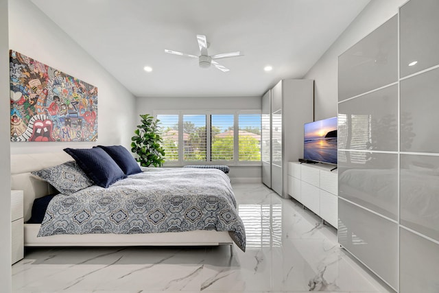 tiled bedroom with ceiling fan and lofted ceiling