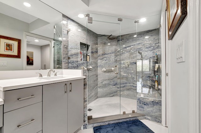 bathroom with tile flooring, an enclosed shower, and vanity