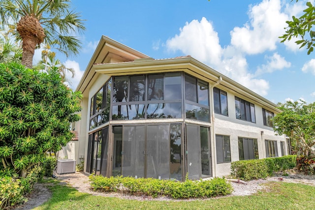 rear view of house featuring a sunroom