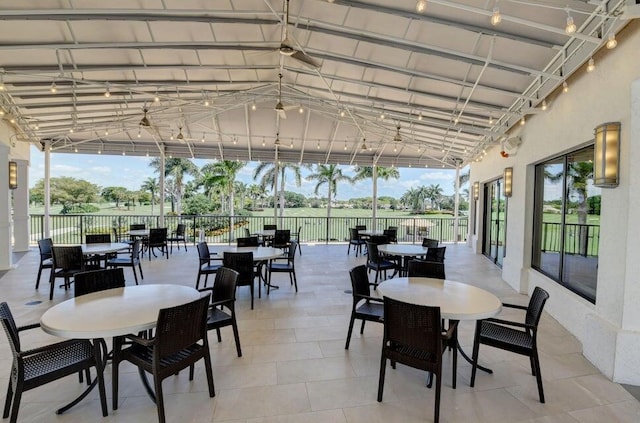 tiled dining area with vaulted ceiling